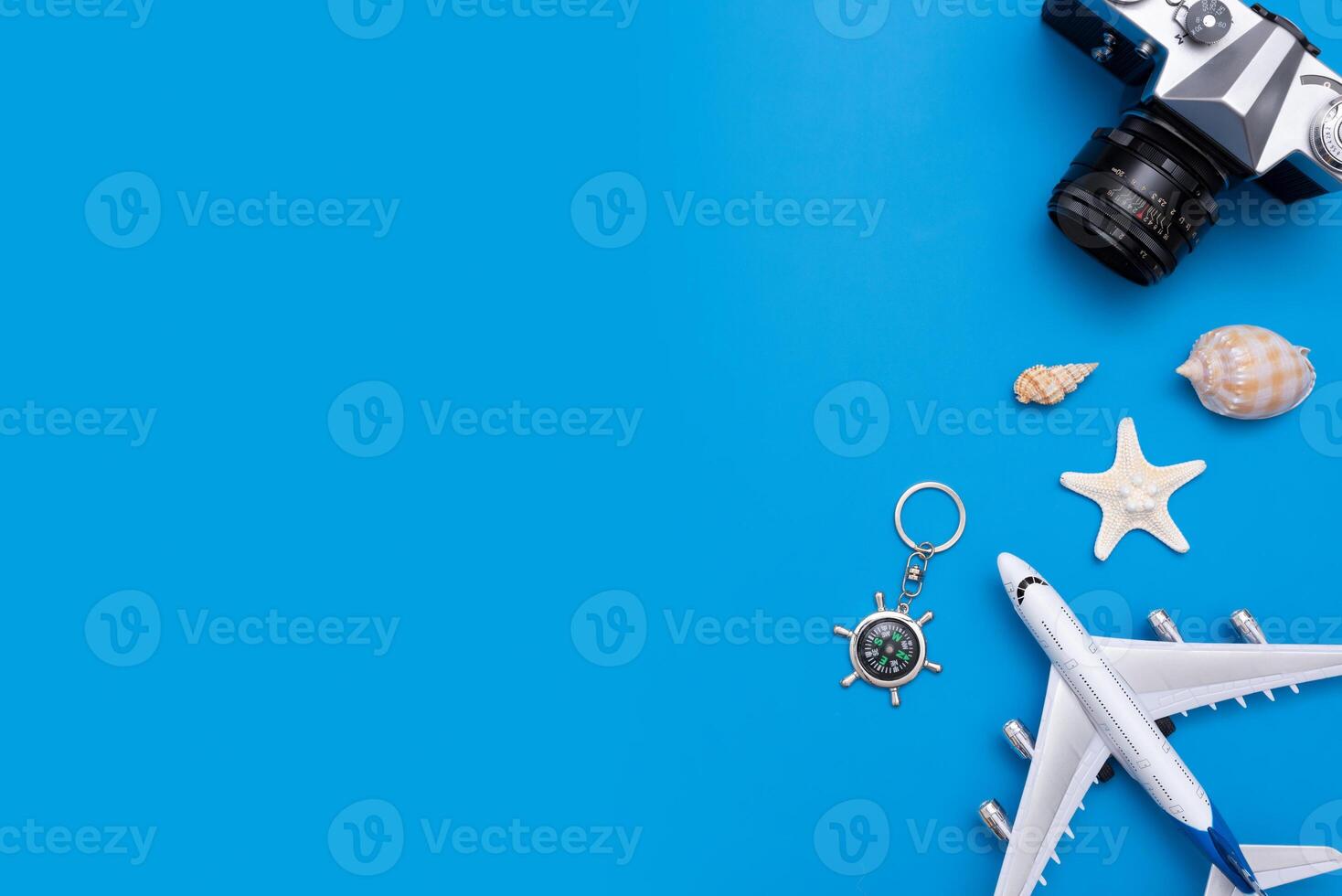 A camera, keychain, and a starfish are on a blue background photo