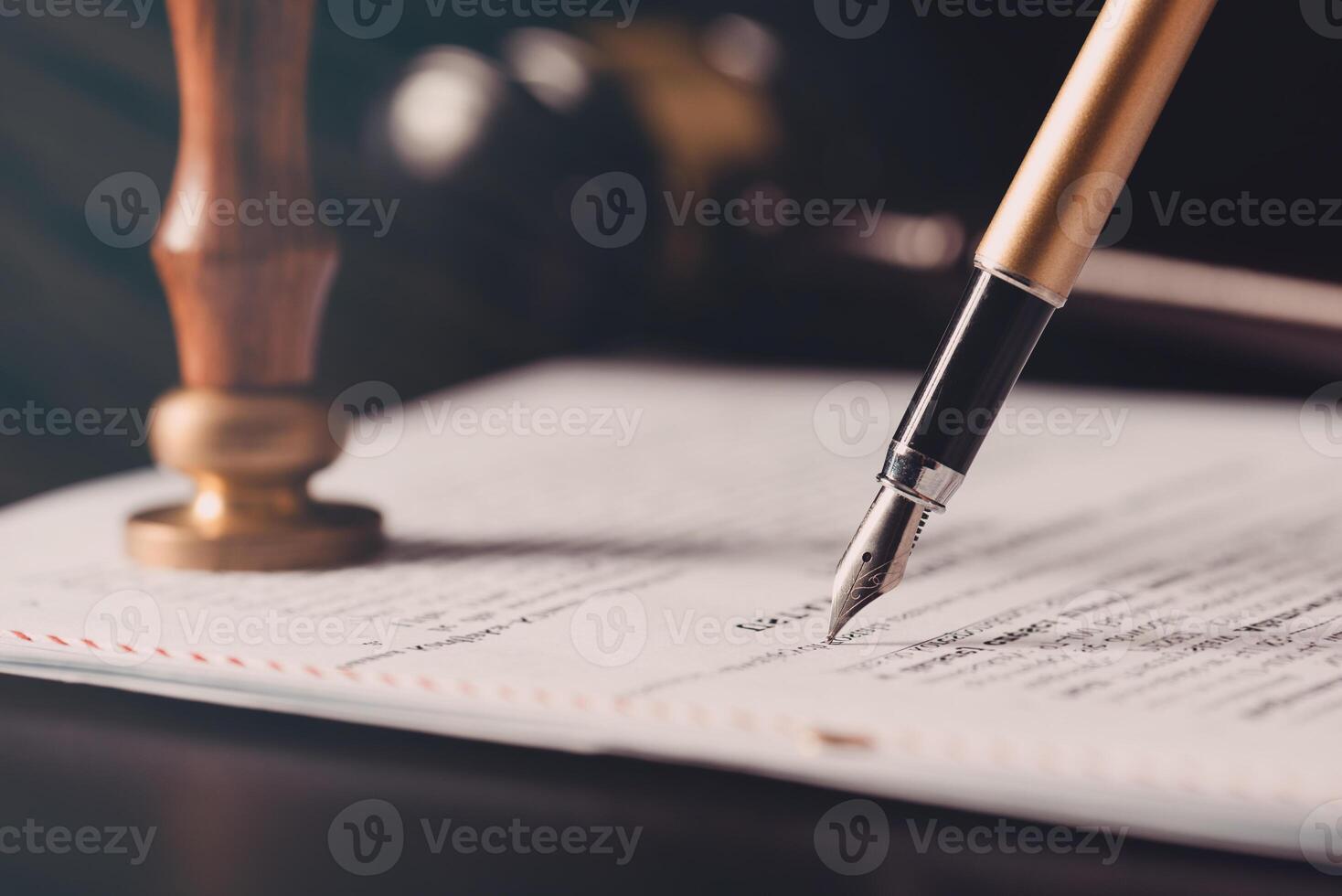 Pen on paper with a gavel and a pen on top of it photo