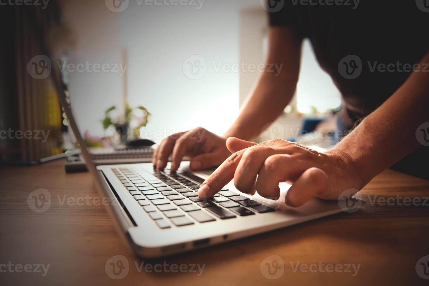 A person typing on a laptop computer photo