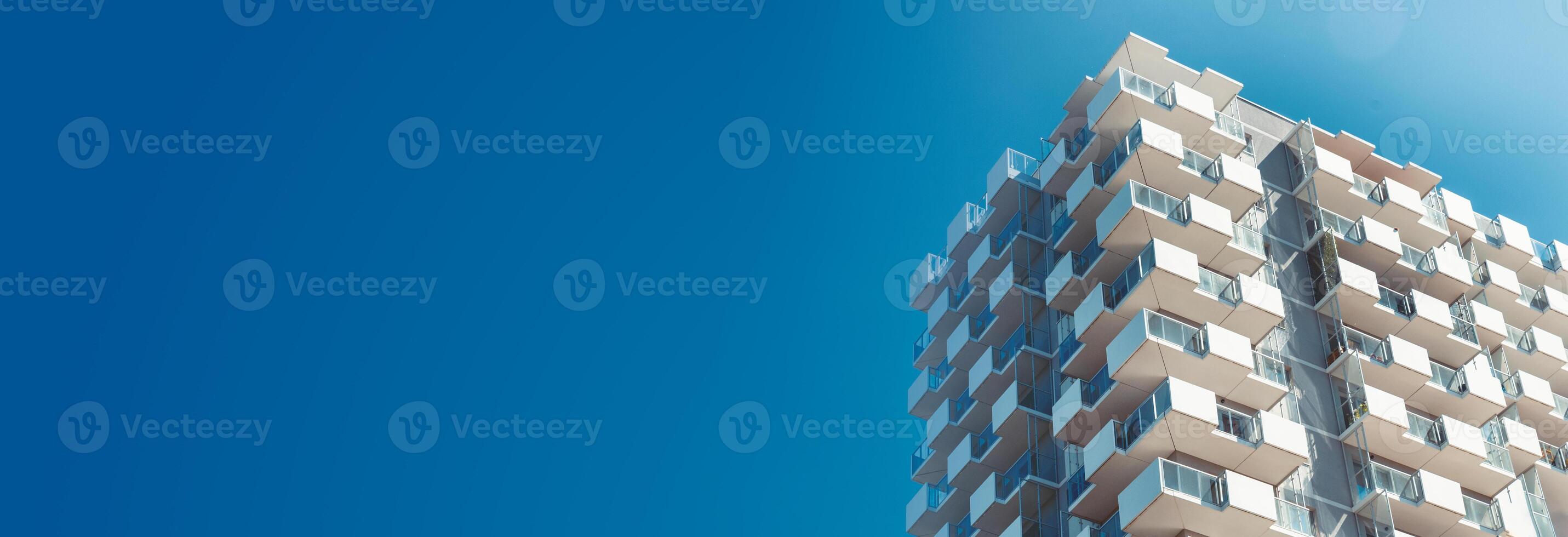 A tall building with a blue sky in the background photo