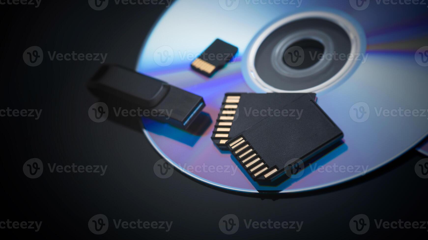 A cd and a flash drive sitting next to each other photo