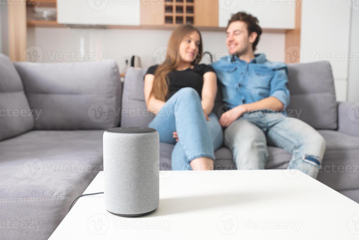 A man and woman sitting on a couch with an amazon echo photo