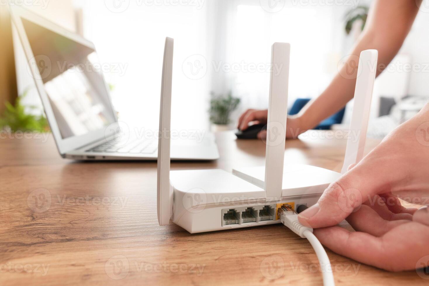 A person is holding a router on a table photo