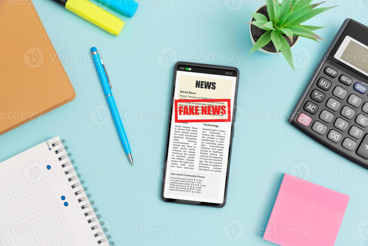 News on smartphone and notebook on blue background photo