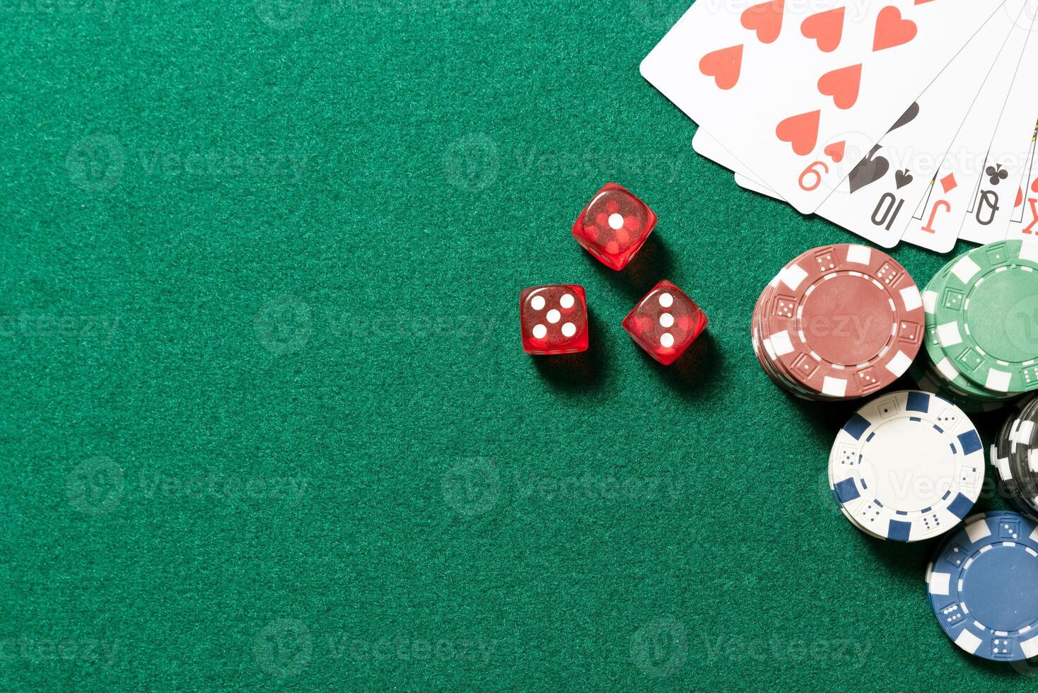 A green table with poker chips and cards photo