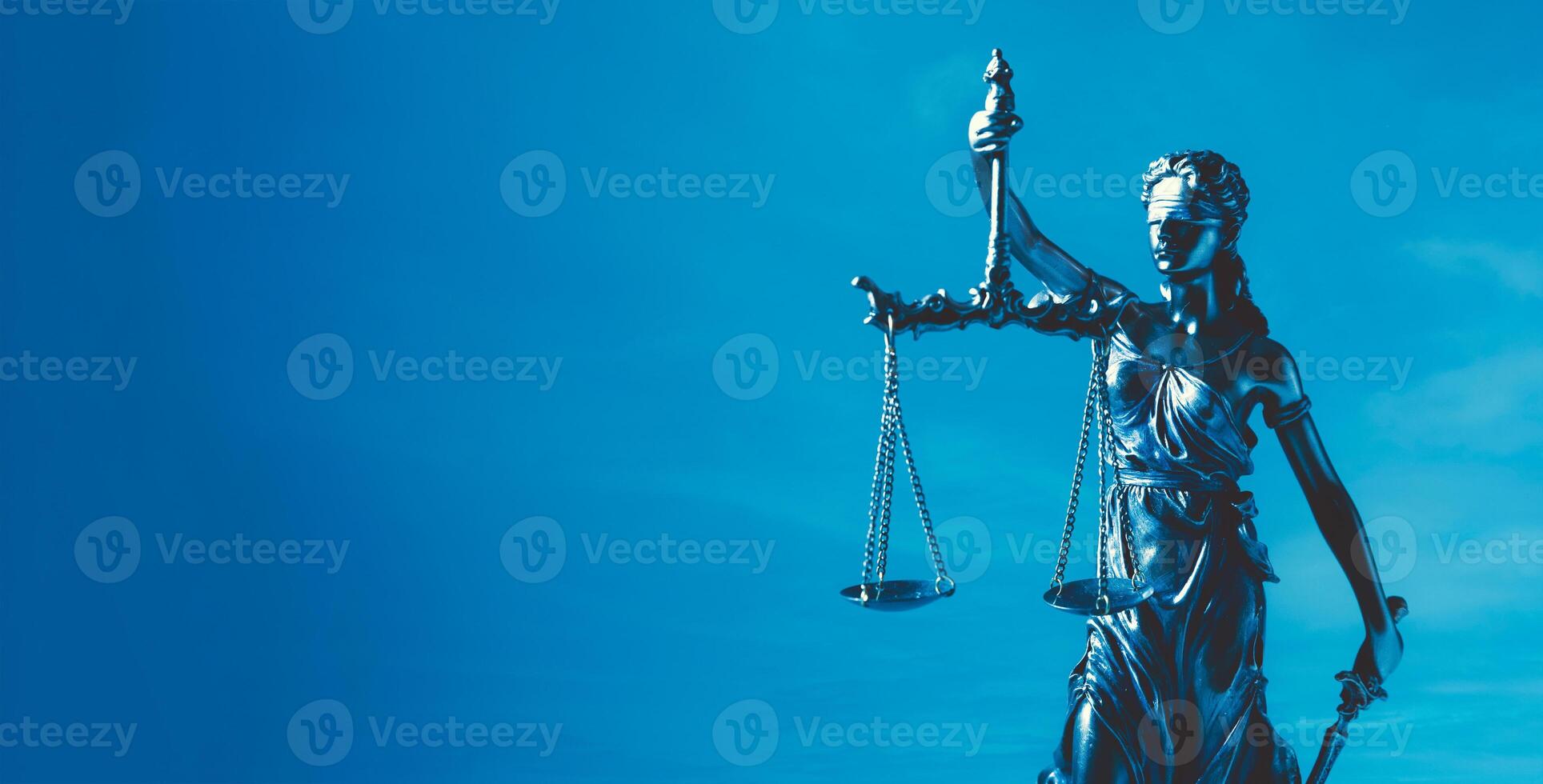 A statue of lady justice holding a scale photo