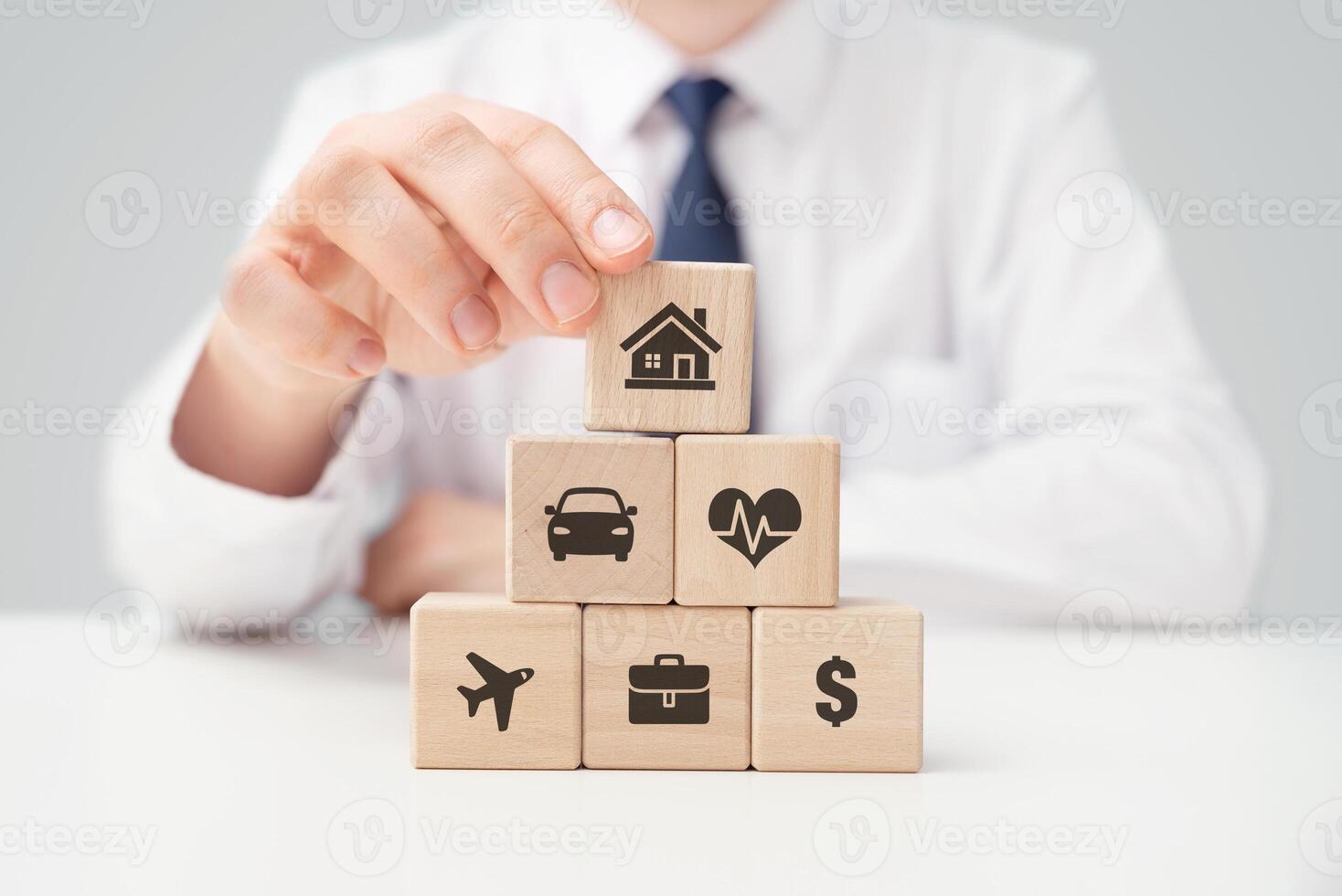 A man is holding wooden blocks with icons on them photo