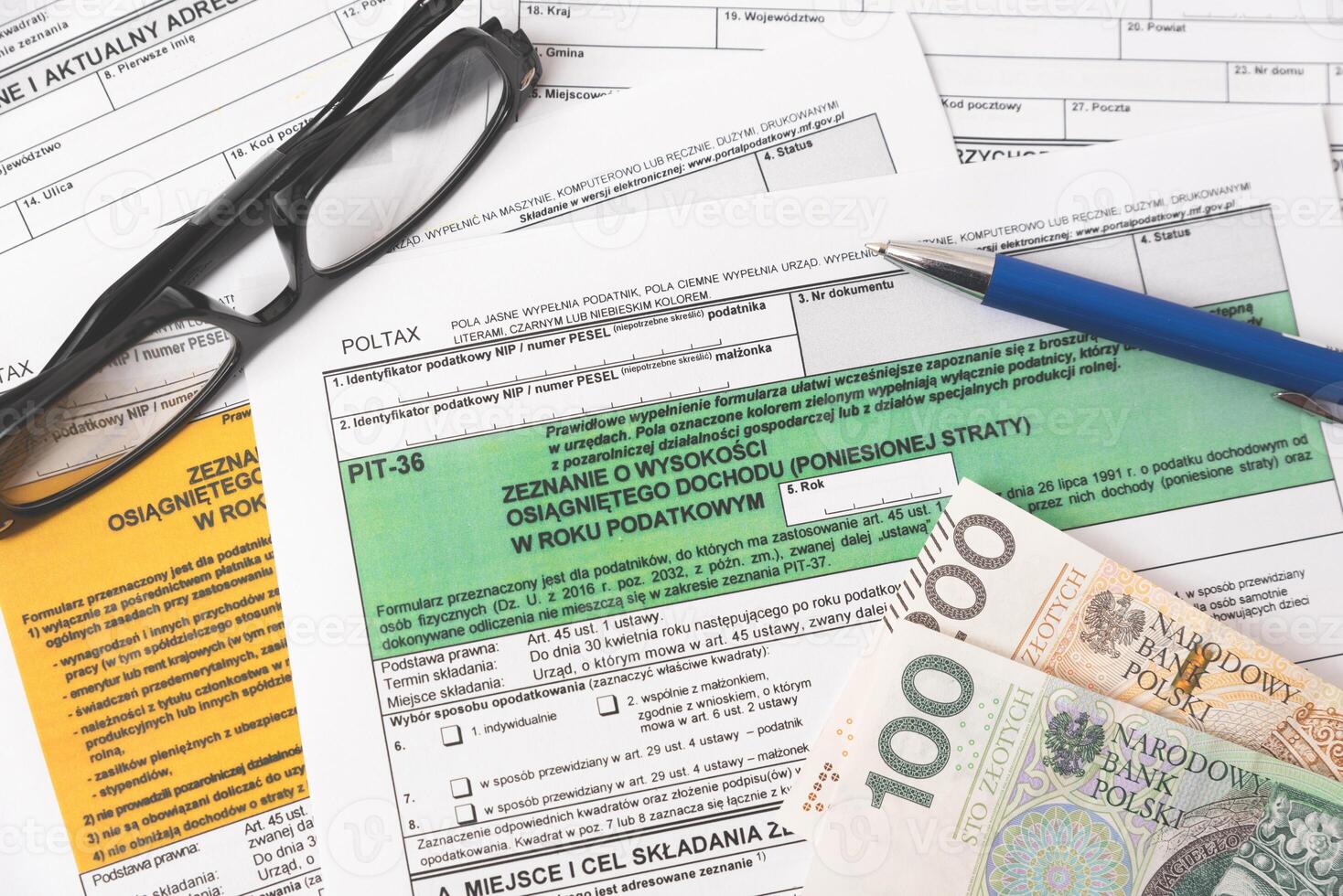 Tax forms and pen with money photo
