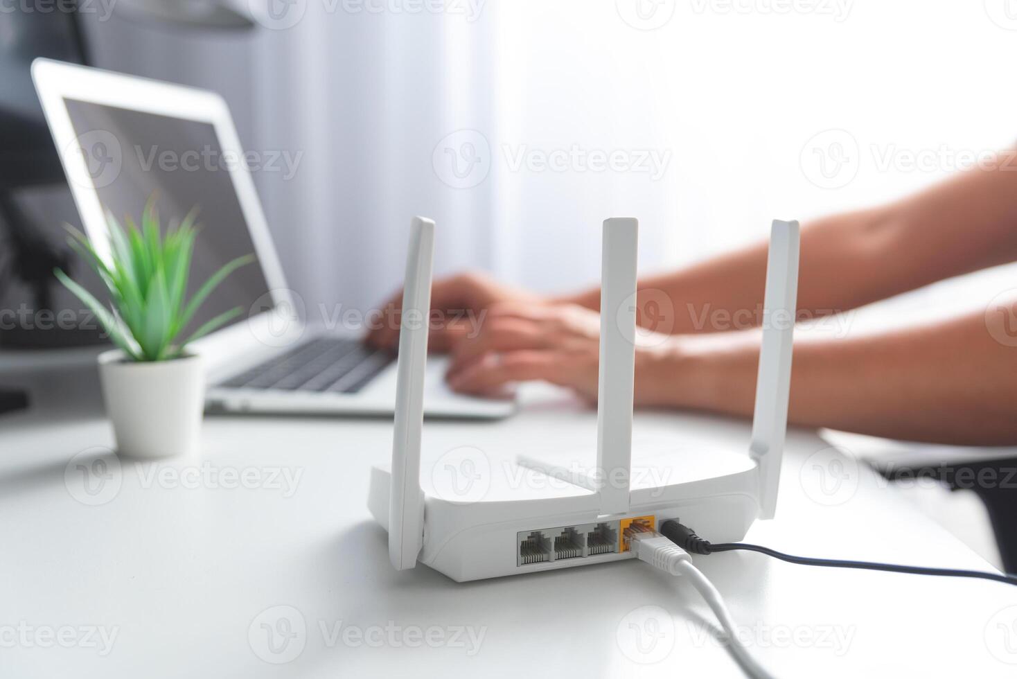 A person is using a router on a desk photo
