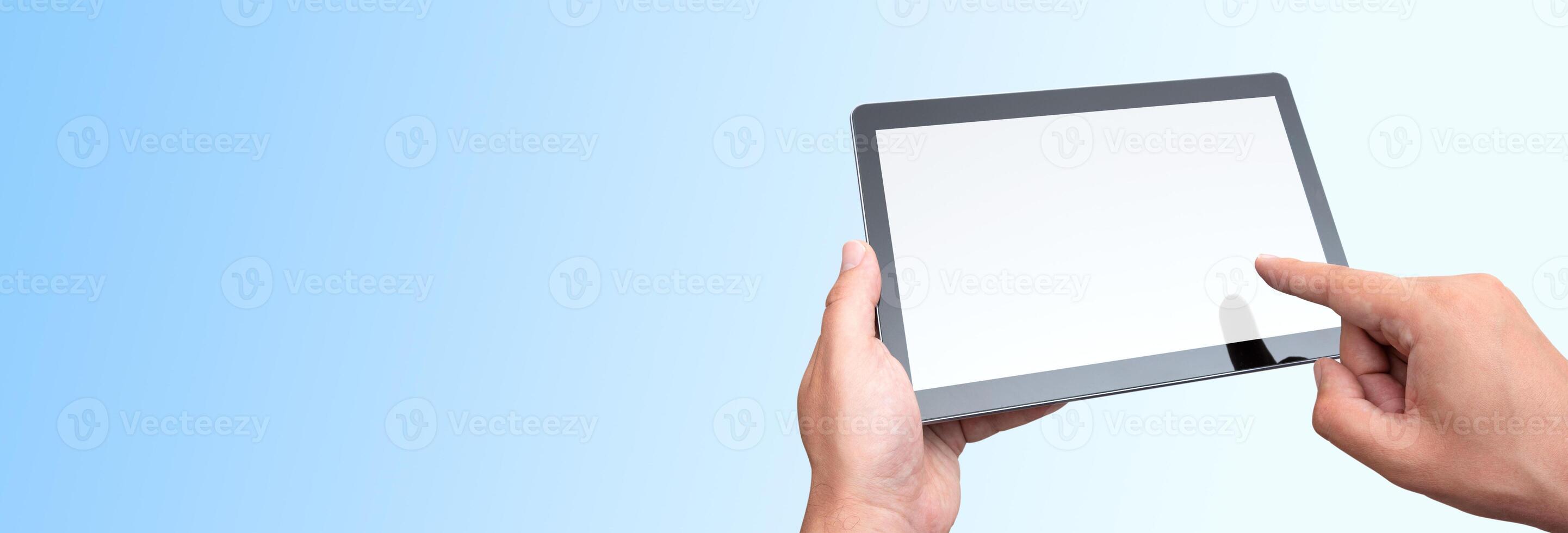 A person holding a tablet computer with a blank screen photo