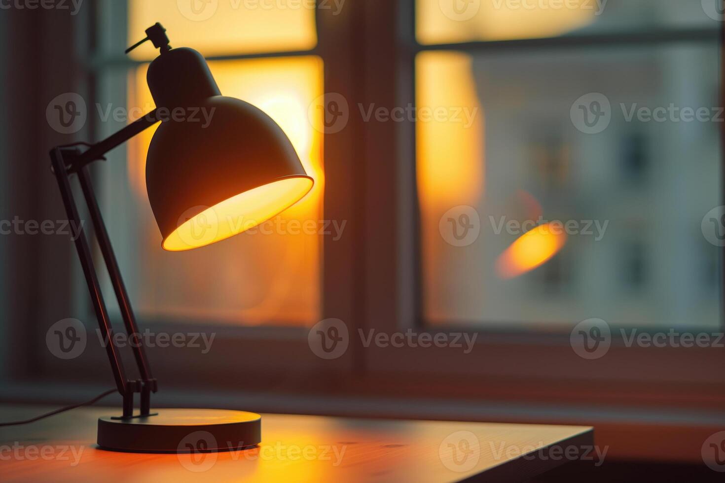 A lamp is on a table next to a window photo