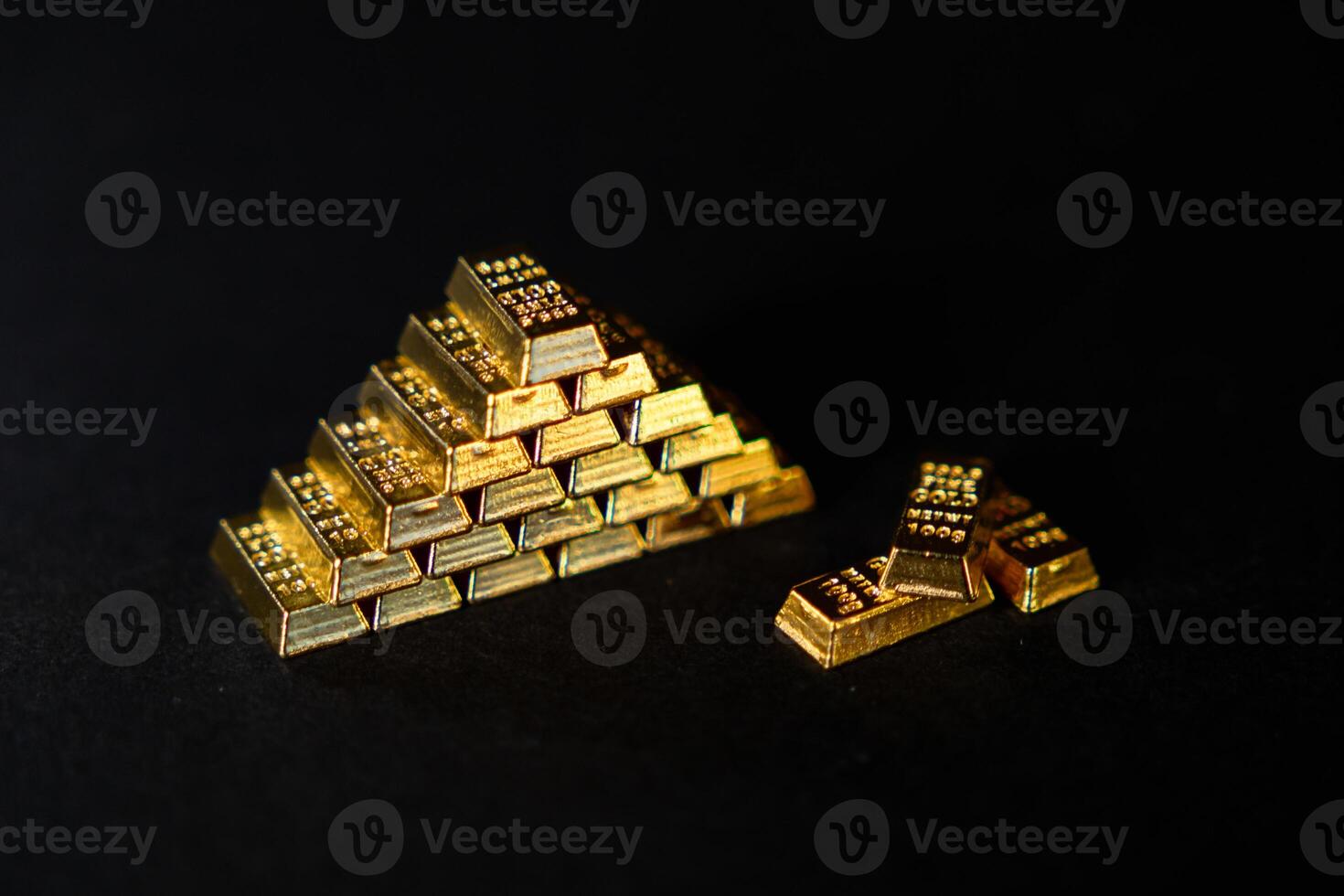 pyramid of shiny gold bars on a dark background, symbolizing wealth, investment, financial stability, and luxury in the world of precious metals and assets photo