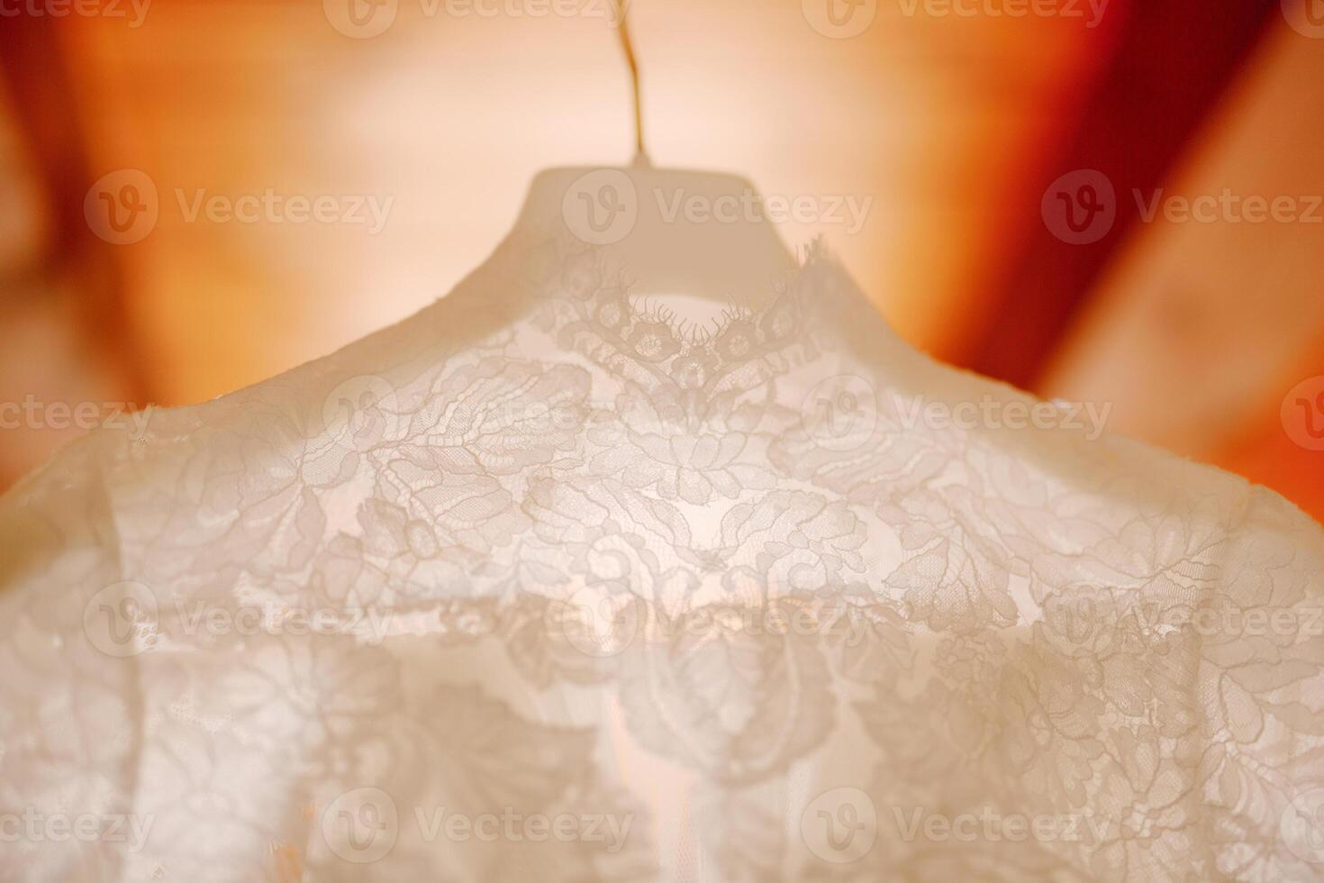 An Elegant Lace Dress Beautifully Hanging in Soft Natural Light photo