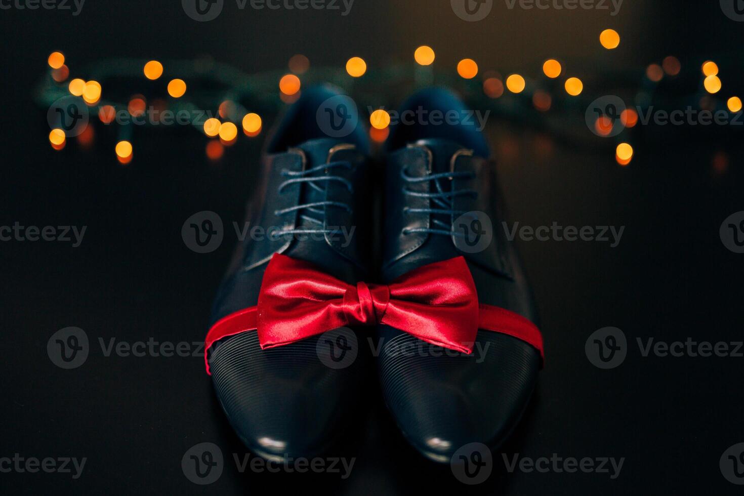 Elegant and Stylish Shoes with a Red Ribbon on Dark Surface photo