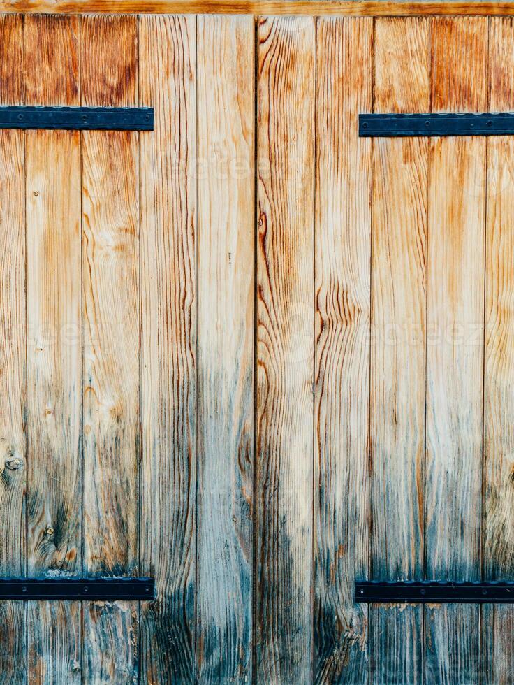 Beautiful Rustic Wooden Double Doors Enhanced with Iron Hinges photo