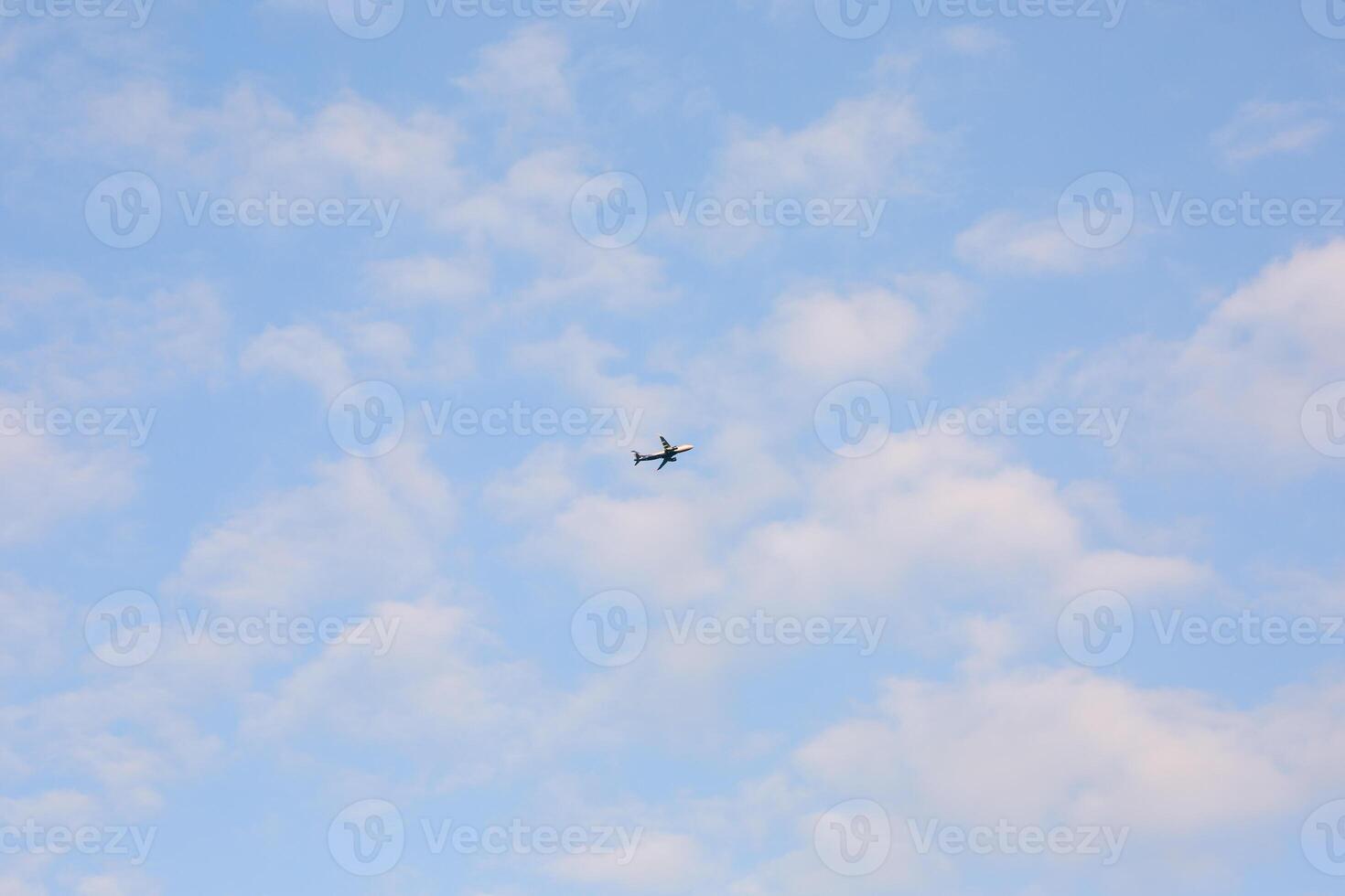 Enjoy the view of aircraft soaring in a blue sky with clouds photo