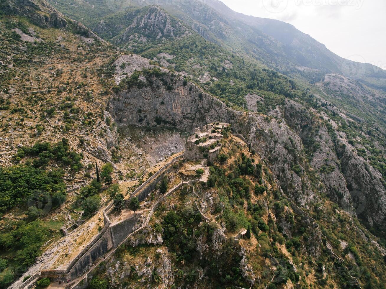 Walls of St. John fortress on a rocky mountain in Kotor. Montenegro. Drone photo