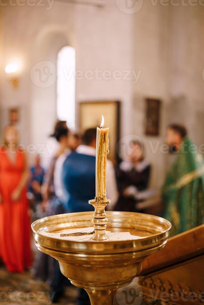 A Candle is Lit during a Traditional Ceremony Event at Church photo