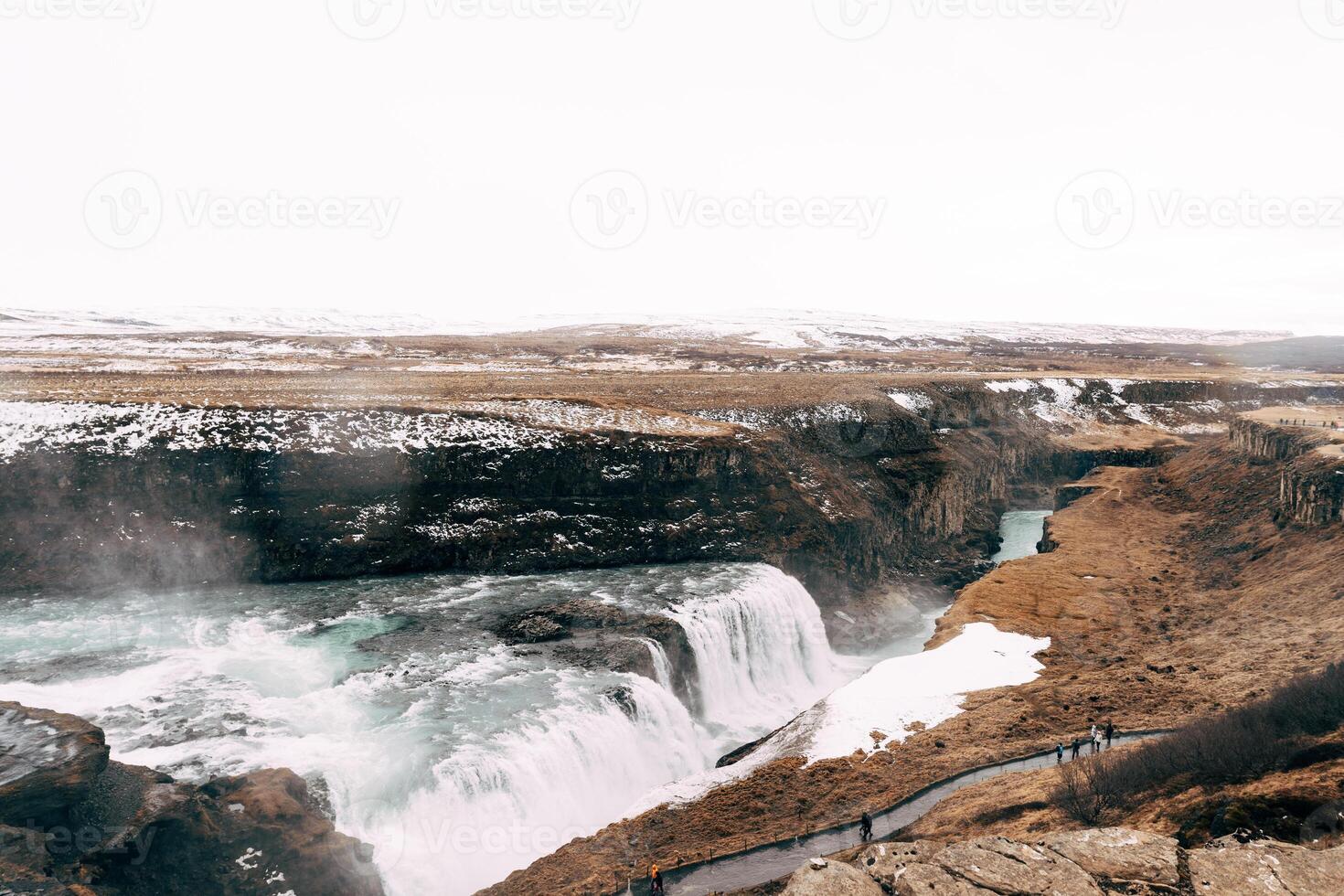 A Majestic Waterfall Amidst the Stunning Landscape of Iceland photo