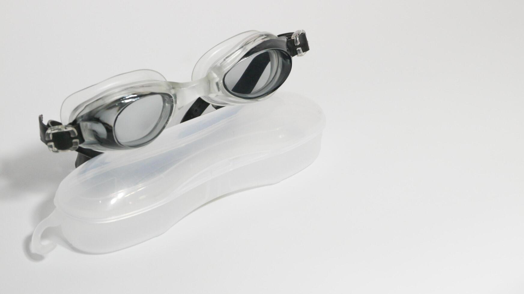 Black swimming goggles isolated on white background. photo