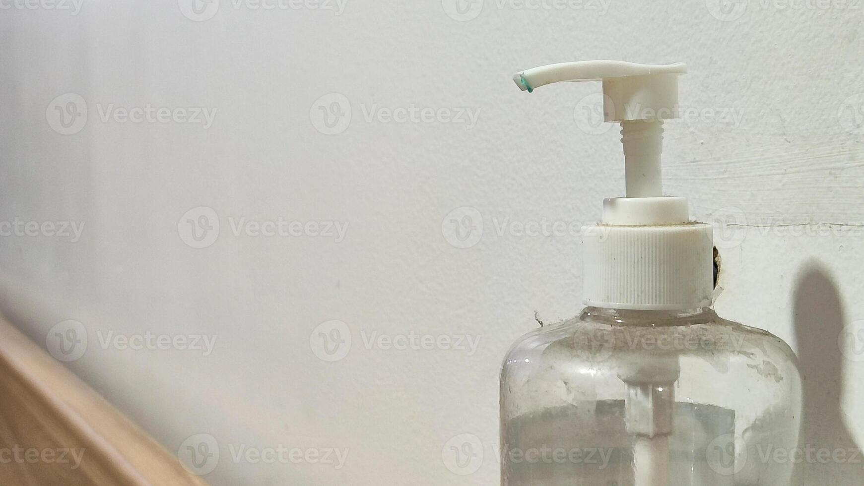 Hand sanitizer hanging on the wall photo