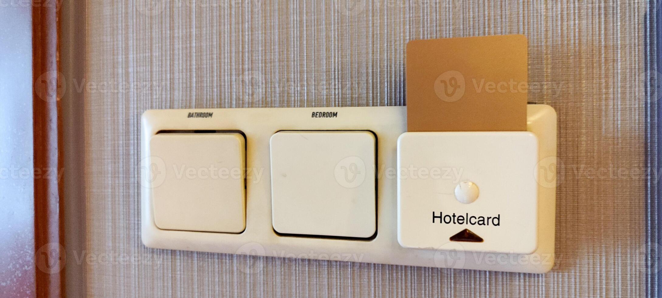 inserting a card key into a switch in a modern hotel room during the day. photo