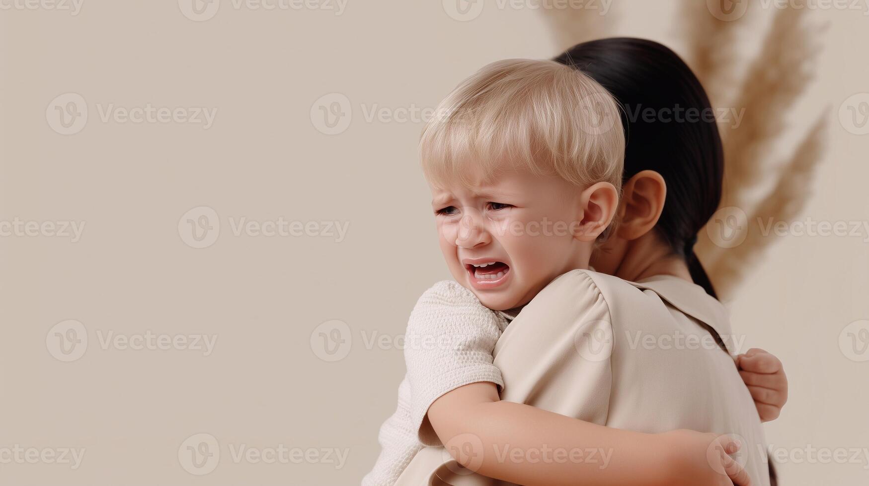 A distressed toddler clings to a comforting adult, expressing fear, confusion, and emotional overwhelm capturing themes of parenting, attachment, and early childhood stress. . photo