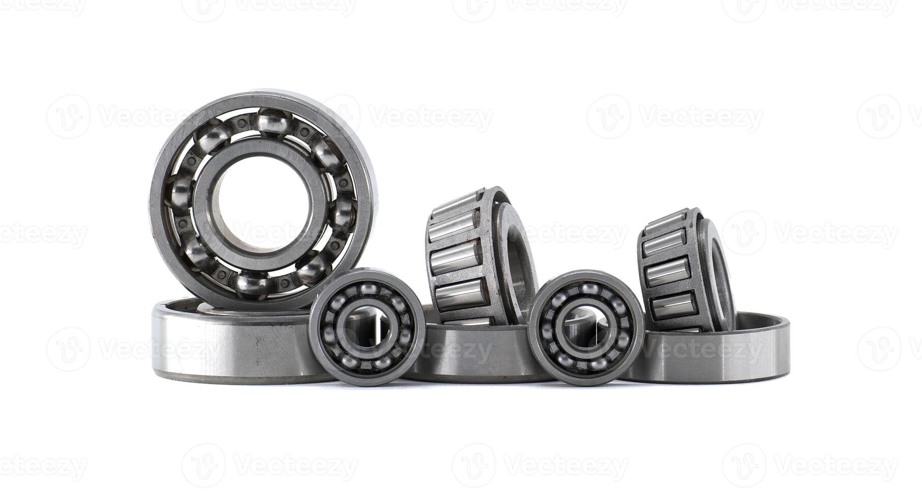 Several ball and roller bearings showcased on a white surface, ready for applications. photo