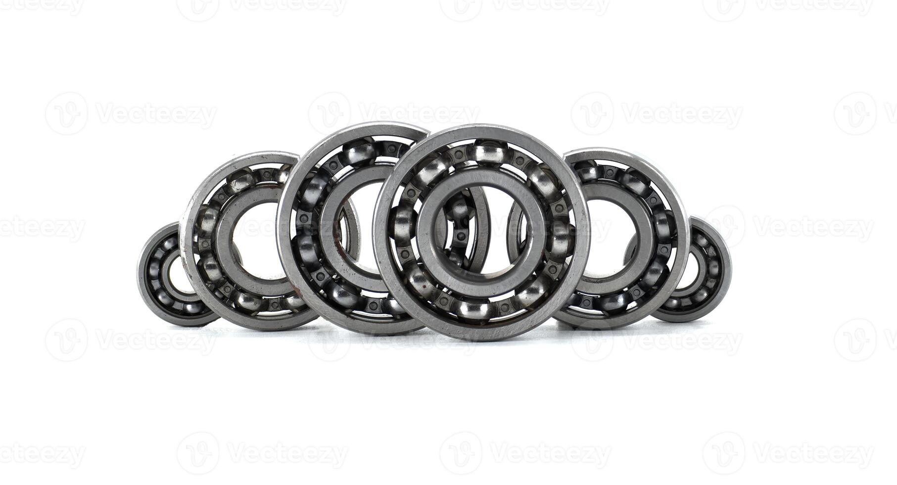 Several ball bearings neatly arranged in front of a white background, ready for use. photo