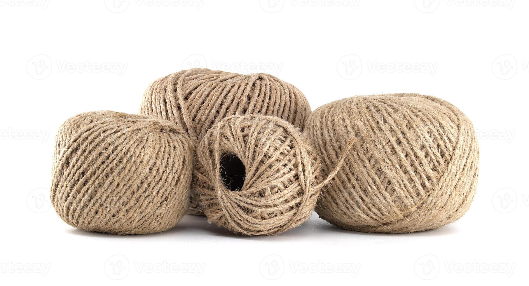 Closeup of four textured twine balls, creating a natural and rustic display against a white backdrop photo