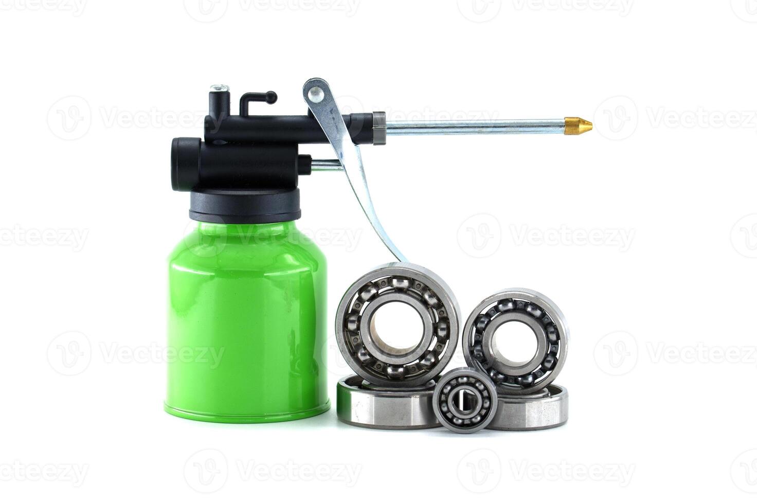 Grease gun lubricating ball bearings isolated on white background photo