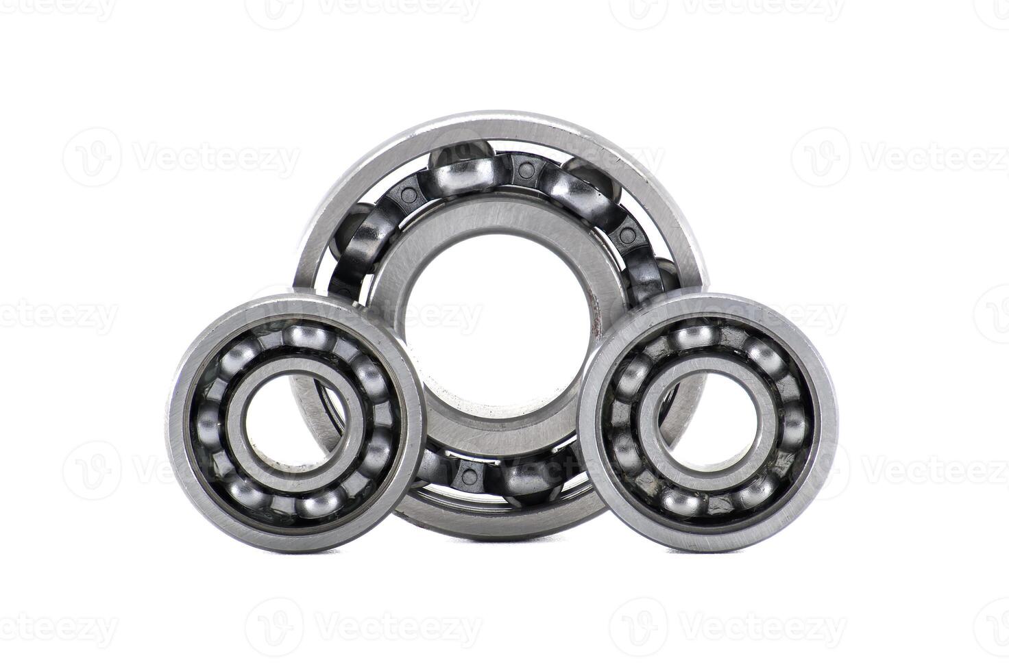 Three metallic ball bearings forming a triangular shape isolated on white background photo