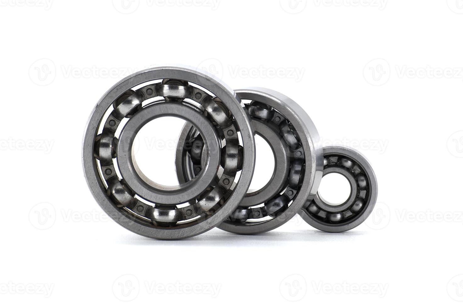 Various sized ball bearings neatly arranged against a plain white backdrop, showcasing engineering design. photo