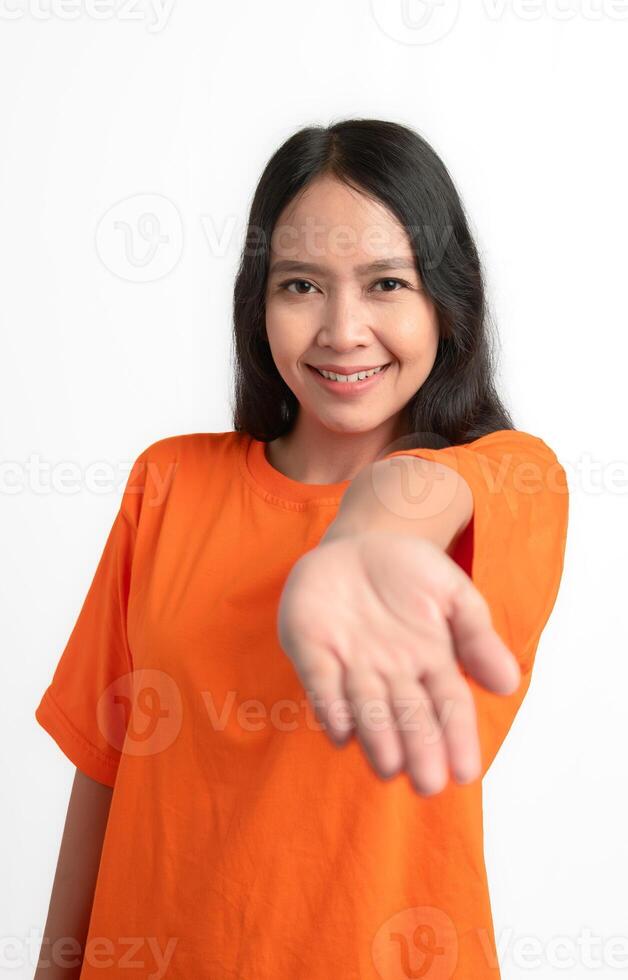 A woman smiling and offering palm hand giving assistance and acceptance. photo