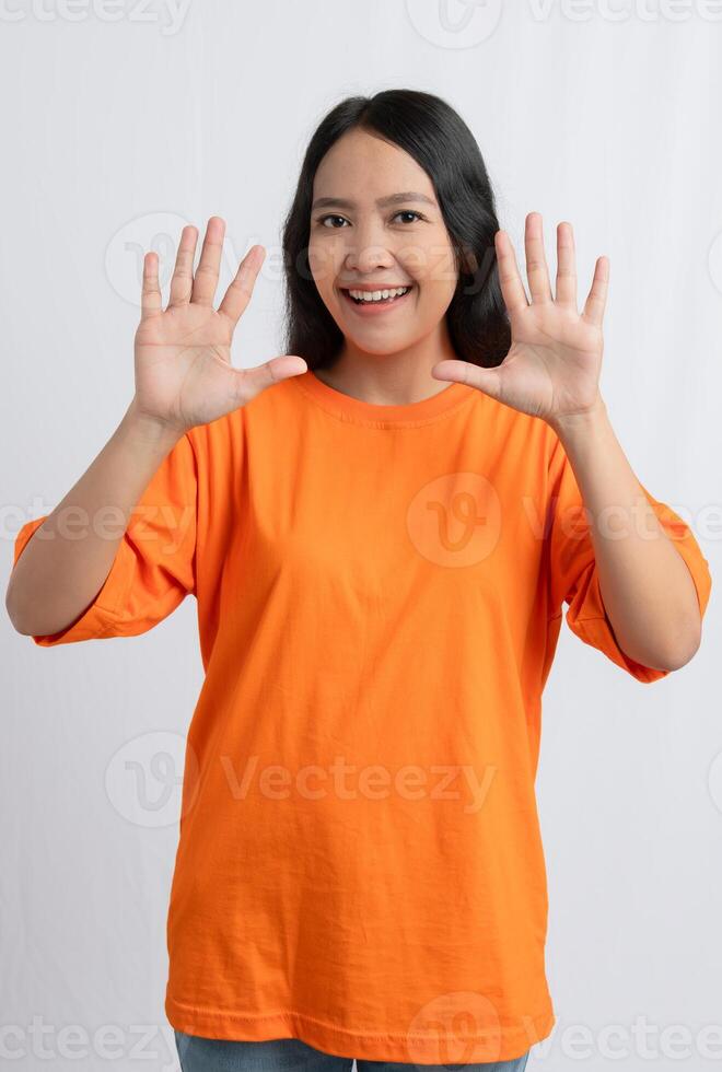 A woman smiling and holding up both hands showing her palms photo