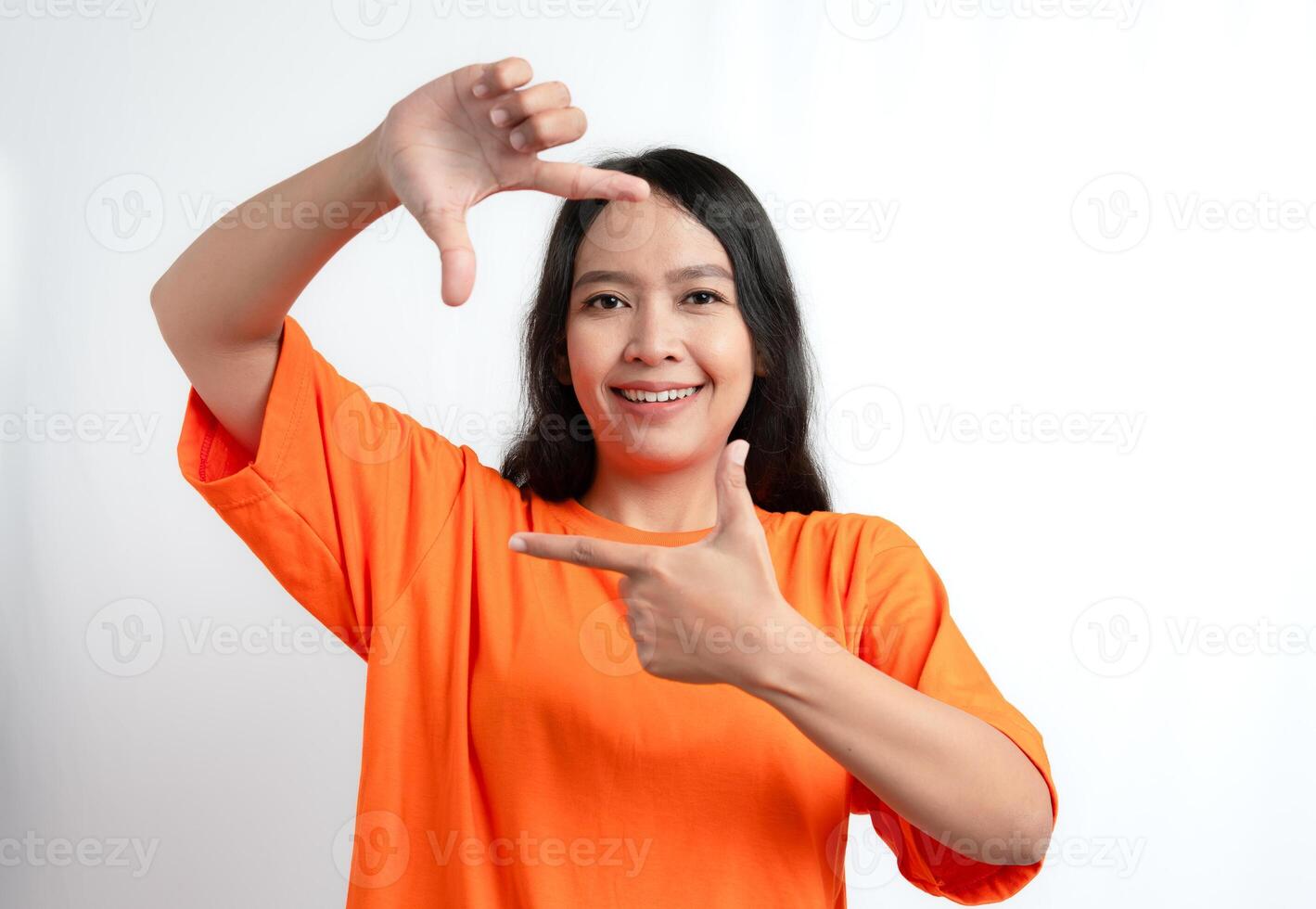 A woman smiling and making a frame with her hands photo