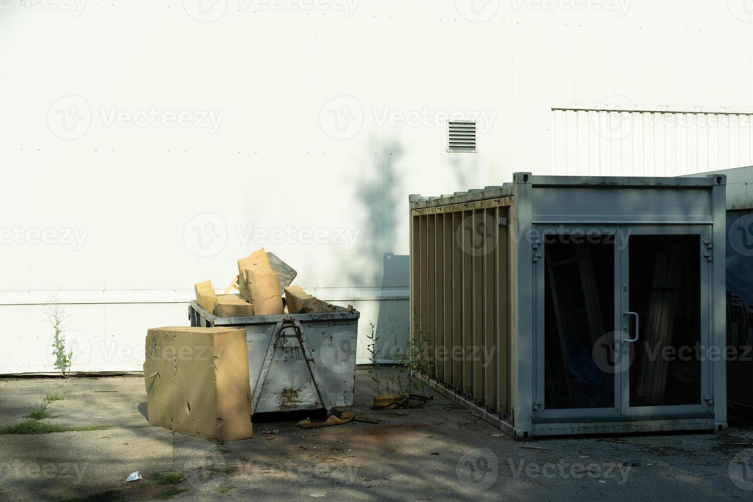 Waste Container with Foam Packaging Material on Asphalt photo