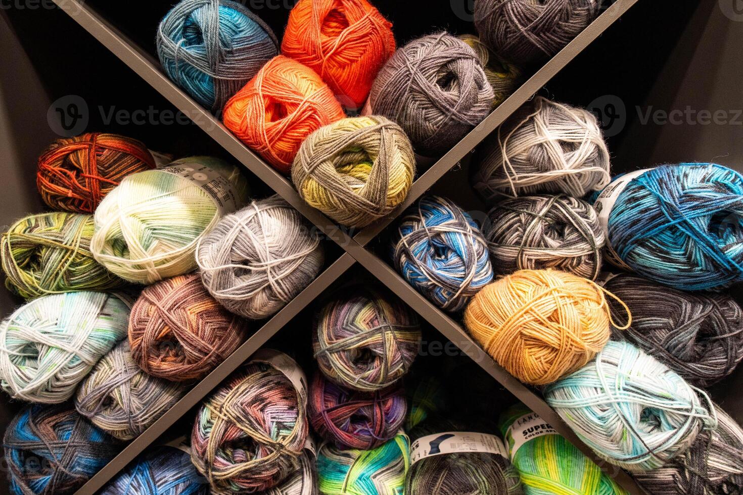 Colorful Yarn Balls Neatly Organized on Shelves photo
