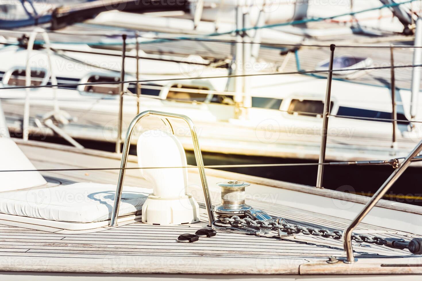 Yachts moored at marina with focus on deck details, nautical concept, sunny background photo