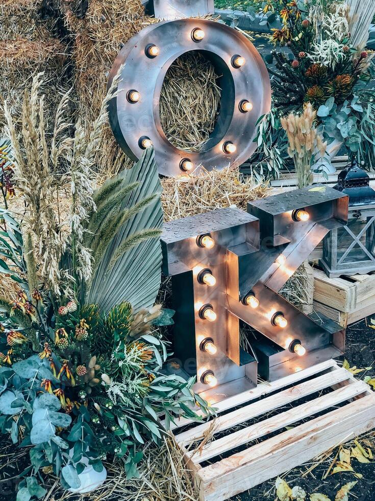Rustic fall decor with illuminated letters in a festive autumn setting photo