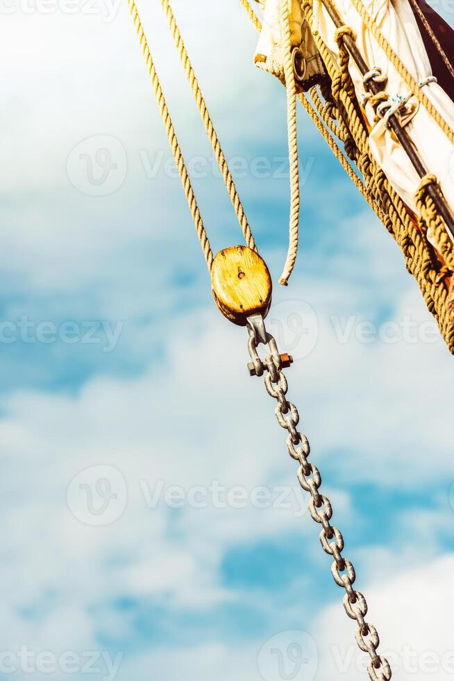 Sailboat rigging details against bright sky background, ocean theme photo