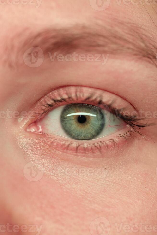 A CloseUp of an Eye Showcasing a Unique and Striking Green Color and its Details photo