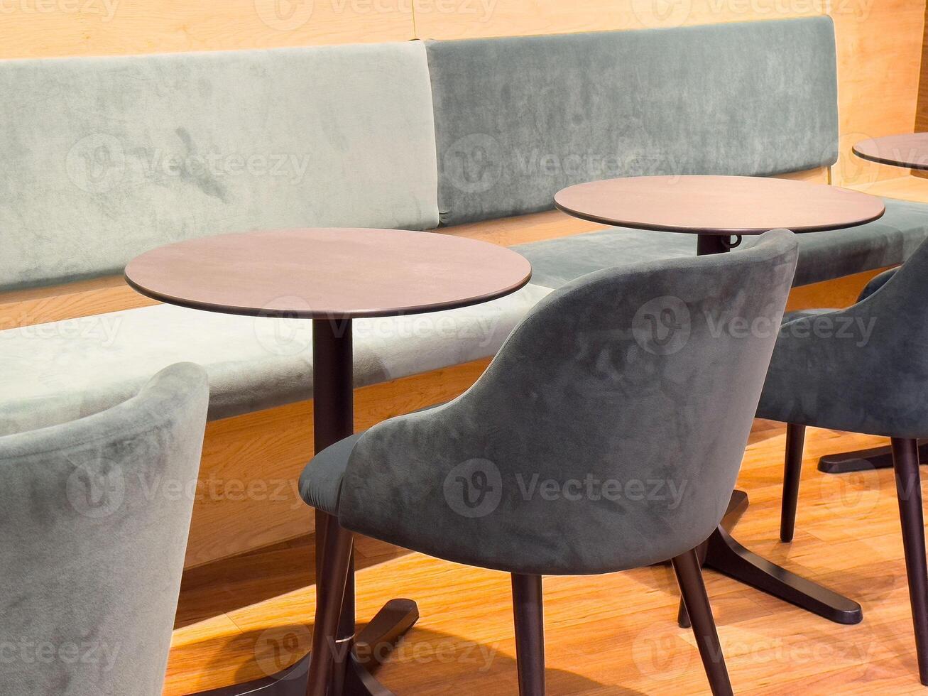 Modern cafe interior with round tables and upholstered chairs photo