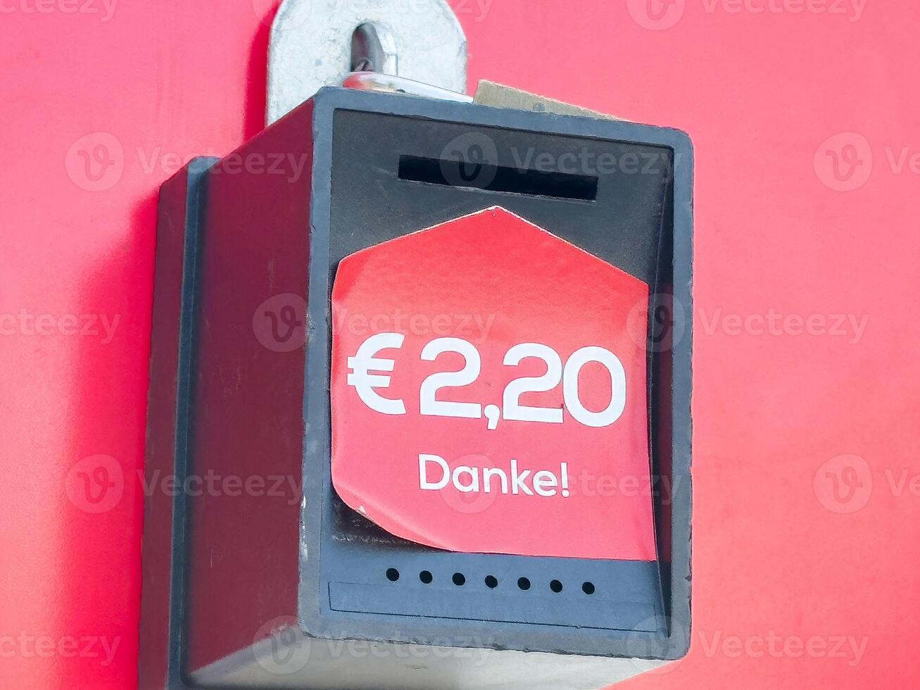 Red ticket machine displaying euro amount with danke text photo