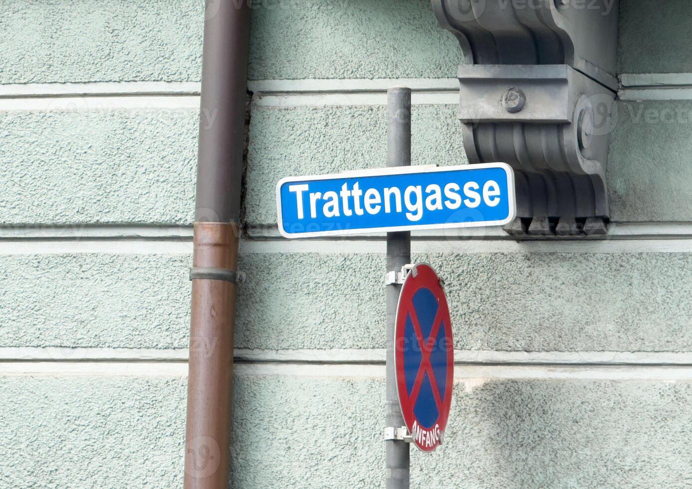 Trattengasse street sign with no parking sign on textured wall photo