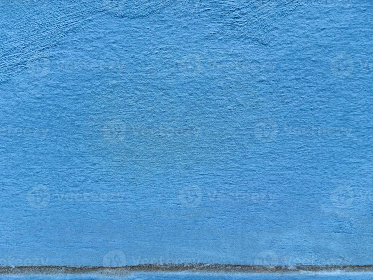 Textured blue wall surface with subtle color variations and minimalist design photo