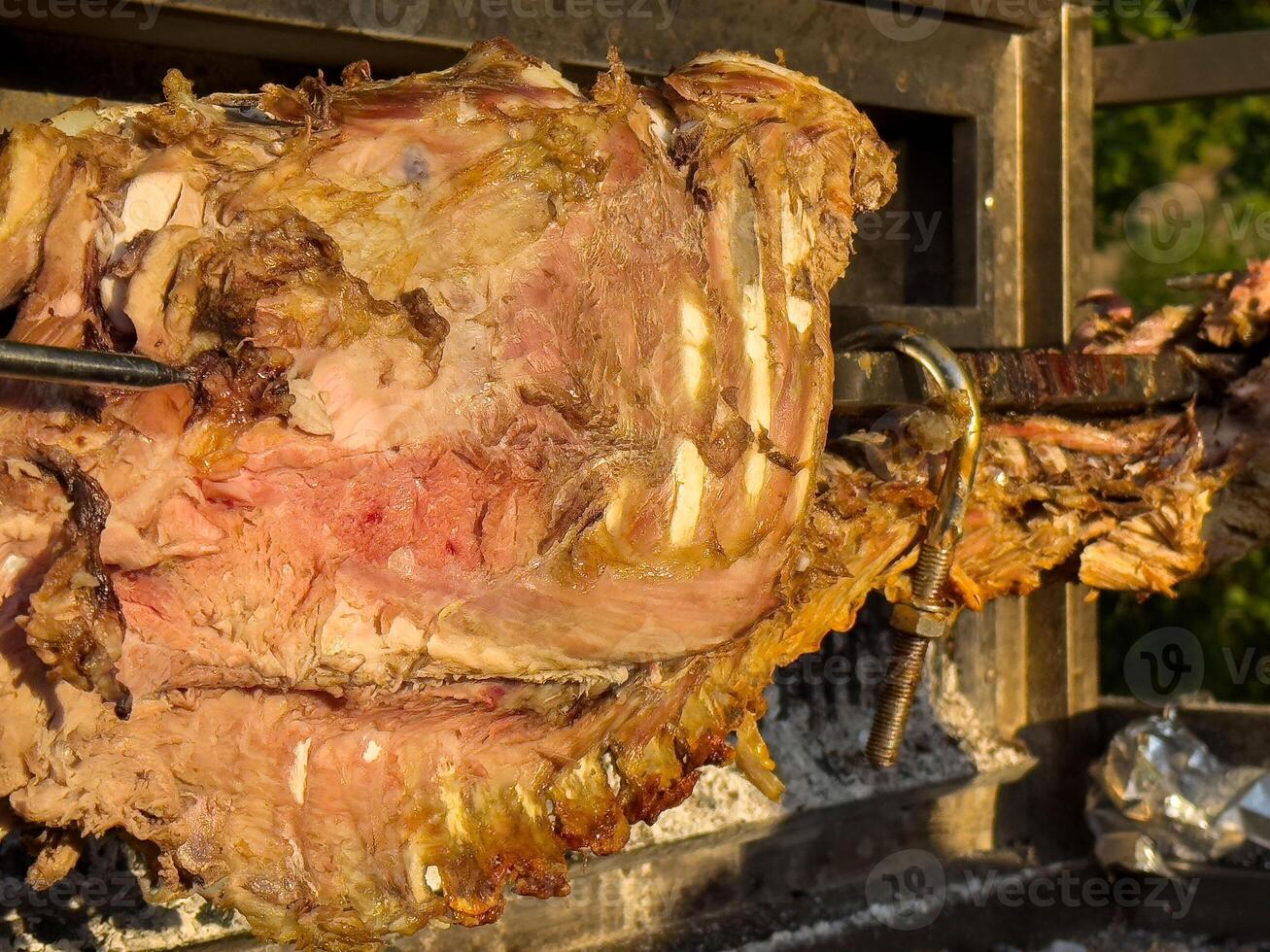 Juicy roasted lamb on a spit with smoky char and tender meat photo