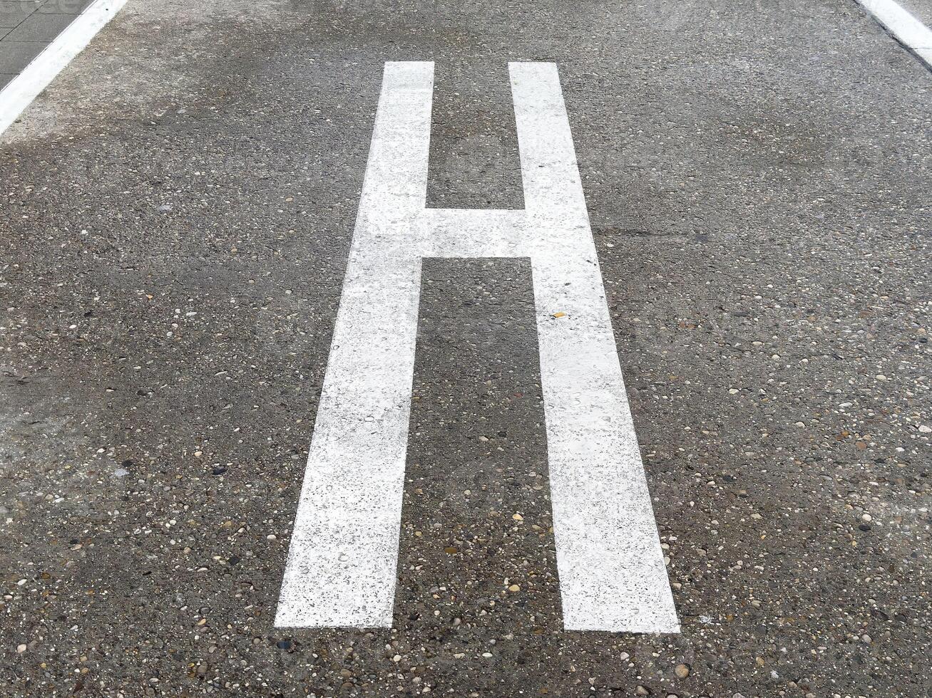 Helicopter landing pad marking on urban concrete surface photo