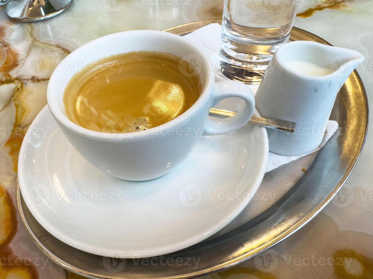Espresso with milk and water on marble table photo