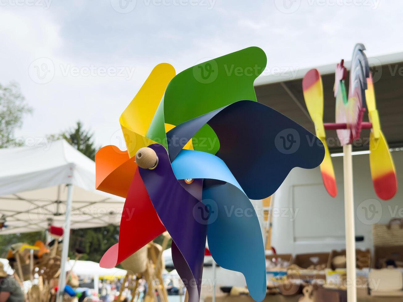 Colorful rainbow pinwheel on a bright day at outdoor market photo